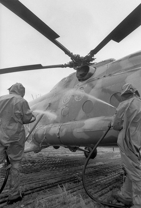 Солдаты в костюмах химзащиты проводят дезактивацию техники после вахты на Чернобыльской АЭС. 1986 г.